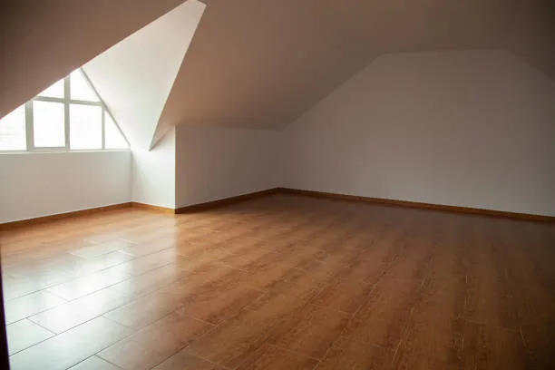 Loft, empty attic room with a wooden floor, white walls and a glass triangular window. Empty place without people. Attic where to carry out activities. Background for montages