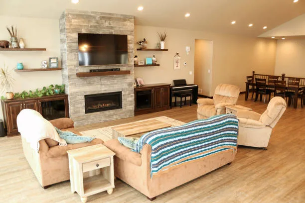 Barnwood tile fireplace with TV in large open concept home family living room and dining room