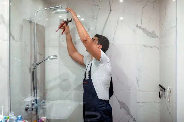 plumber at work in a bathroom, plumbing repair service, assemble and install concept