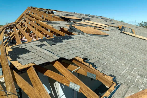 Natural disaster and its consequences. Hurricane Ian destroyed house roof in Florida residential area.