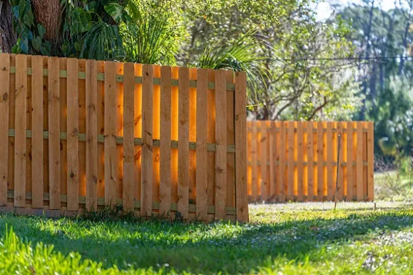 Fence in Florida backyard. Wooden fencing from board planks for grounds protection and privacy.