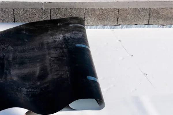 Worker on application Synthetic waterproofing PVC-P and TPO / FPO